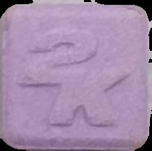 2K (Morado) - MDMA 107mg (Front) pill — lab-tested sample